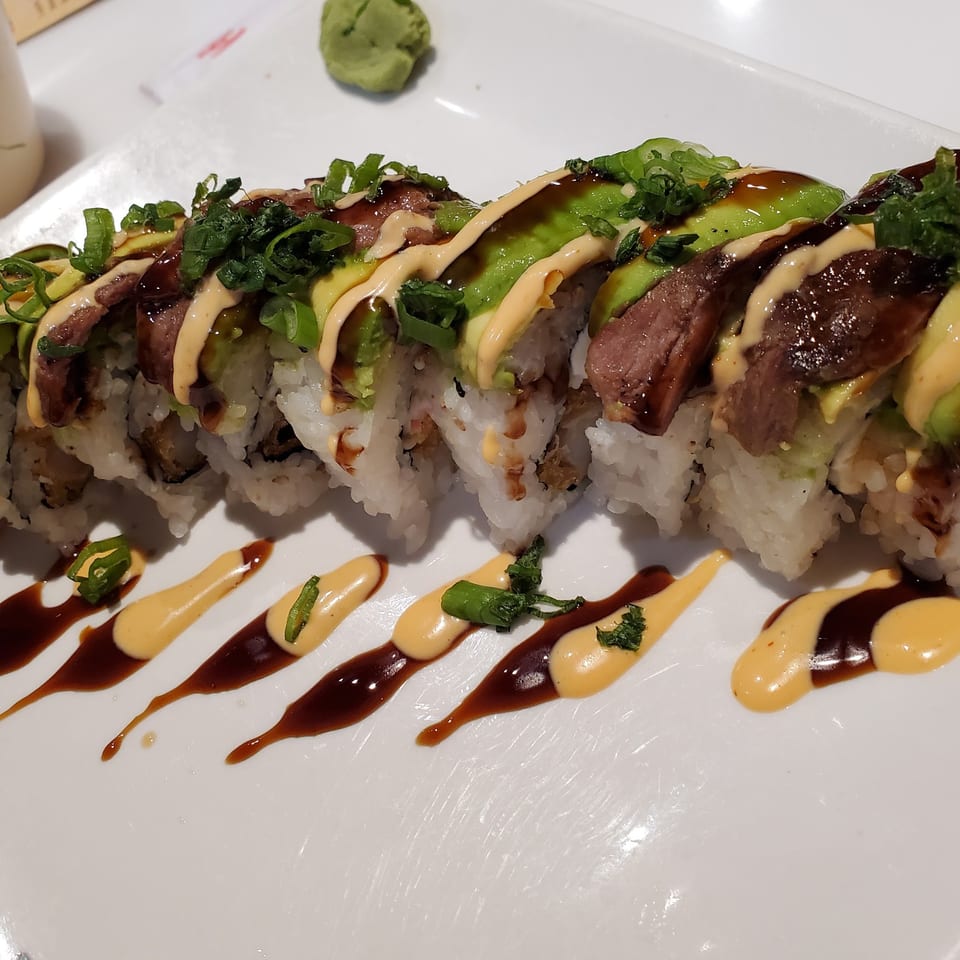 Lim Dynasty Asia Cafe & Xpress's sushi roll with beef, avocado, green onions, and sauces.